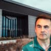 Dan Fallows, Technical Director at Aston Martin, appears serious in front of the team’s headquarters. The backdrop shows the sleek, modern Aston Martin building with the company’s logo above the entrance. The image conveys tension and transition, aligning with the breaking news of his rumored departure from the Formula 1 team.