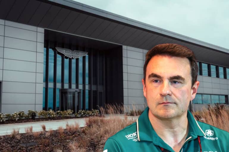 Dan Fallows, Technical Director at Aston Martin, appears serious in front of the team’s headquarters. The backdrop shows the sleek, modern Aston Martin building with the company’s logo above the entrance. The image conveys tension and transition, aligning with the breaking news of his rumored departure from the Formula 1 team.