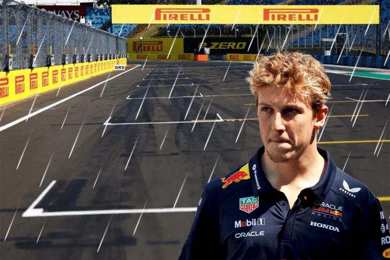 Liam Lawson, wearing a Red Bull Racing shirt, stands under the rain on a Formula 1 starting grid with a somber expression. The empty track behind him and the rainy atmosphere reflect his disappointment after finishing 17th in the race. The Pirelli-branded banners and wet asphalt emphasize the mood of a tough and frustrating race day.