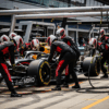 An F1 pit crew works in perfect synchronization, showcasing speed, precision, and high-performance execution in a professional environment.